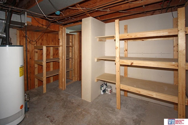 unfinished basement featuring gas water heater