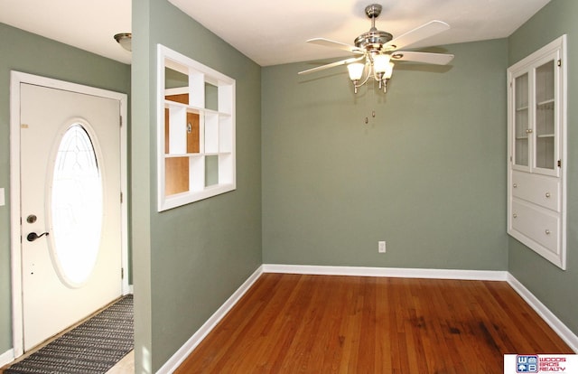 entrance foyer with ceiling fan, baseboards, and wood finished floors