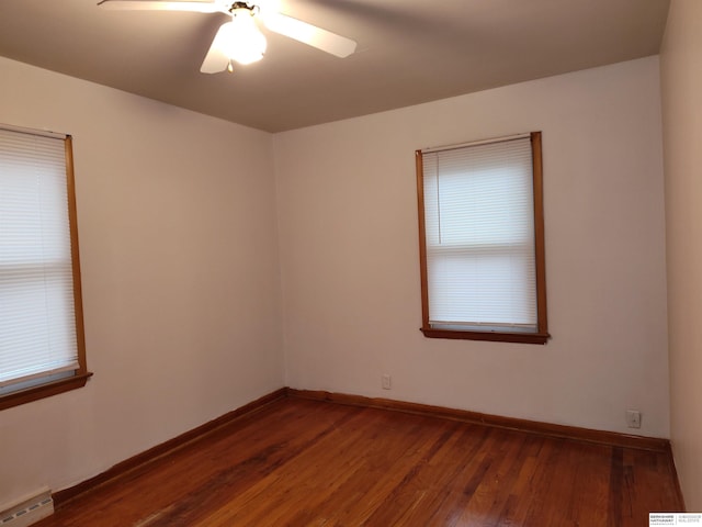 unfurnished room featuring baseboards, a baseboard radiator, a ceiling fan, and wood finished floors