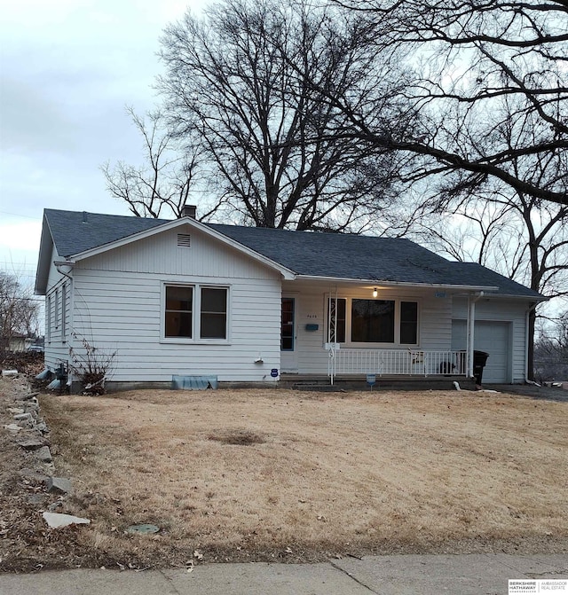 single story home featuring a porch, a shingled roof, a chimney, and an attached garage