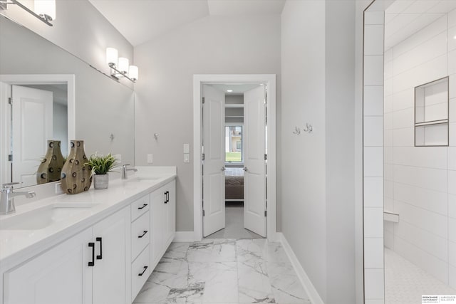 full bathroom with lofted ceiling, marble finish floor, baseboards, and a sink