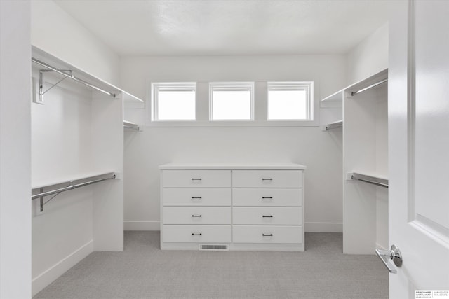 spacious closet with light carpet and visible vents