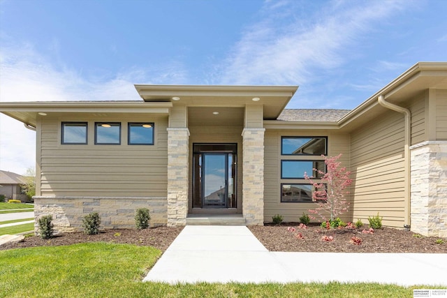 doorway to property with stone siding