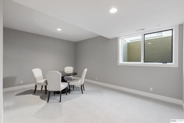 carpeted dining room with visible vents, baseboards, and recessed lighting