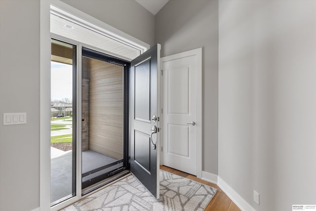 entryway with baseboards and light wood-style floors