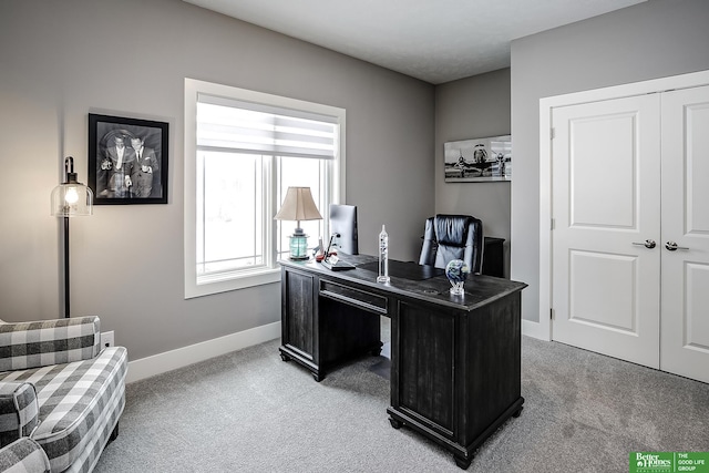 office space featuring light carpet and baseboards