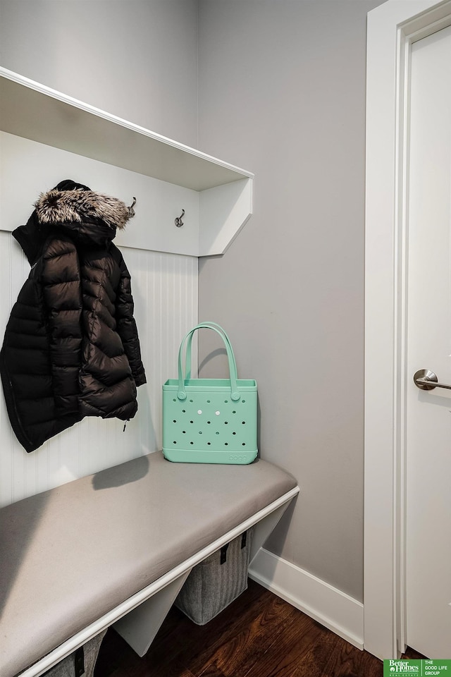 mudroom featuring dark wood-type flooring and baseboards