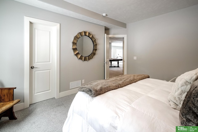 carpeted bedroom featuring baseboards and visible vents