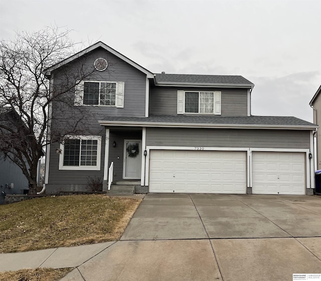 traditional-style house with concrete driveway and a garage