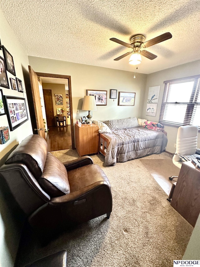 bedroom featuring carpet, ceiling fan, and a textured ceiling