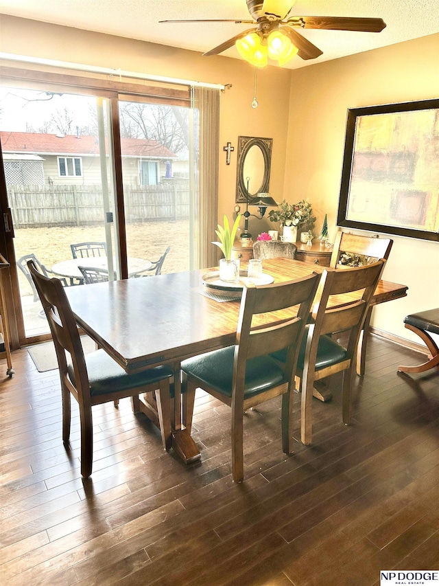 dining space featuring ceiling fan, baseboards, and wood finished floors