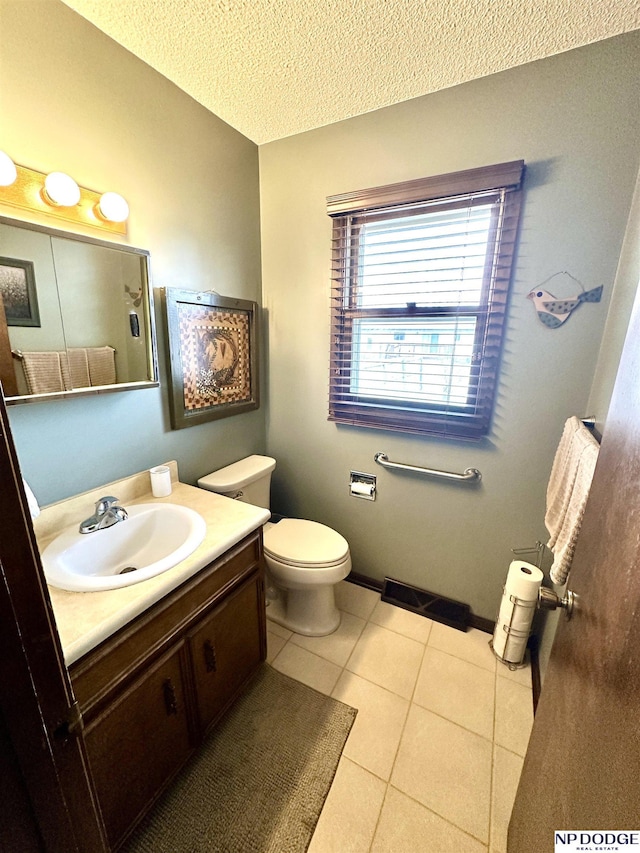 bathroom featuring visible vents, toilet, tile patterned floors, a textured ceiling, and vanity