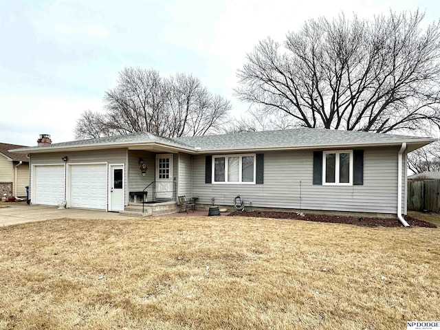 ranch-style house featuring a shingled roof, concrete driveway, an attached garage, fence, and a front yard