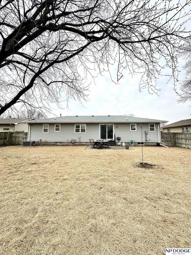 back of house featuring a yard and fence