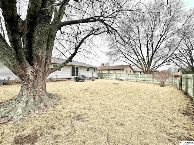 view of yard with central AC and a fenced backyard