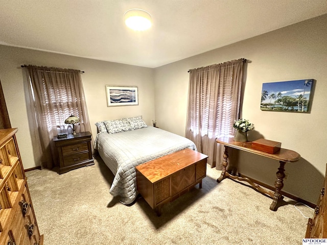 bedroom featuring baseboards and carpet flooring