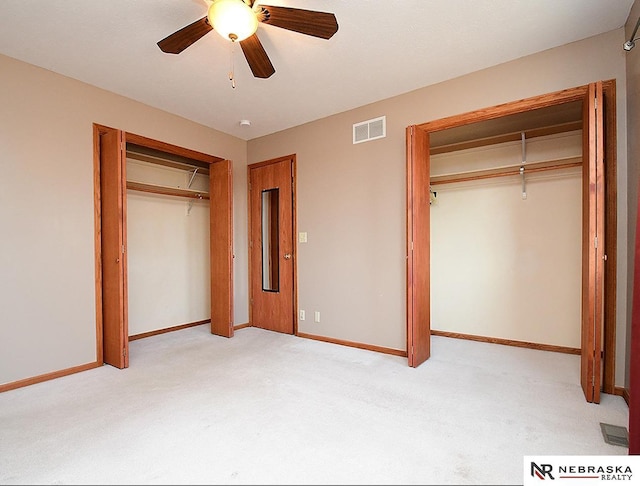 unfurnished bedroom with visible vents, light carpet, and baseboards