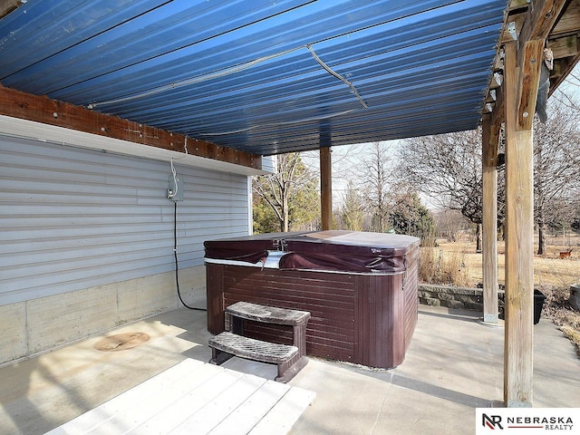 view of patio / terrace with a hot tub