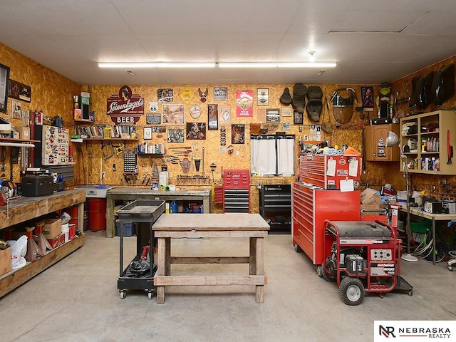 miscellaneous room featuring concrete flooring and a workshop area