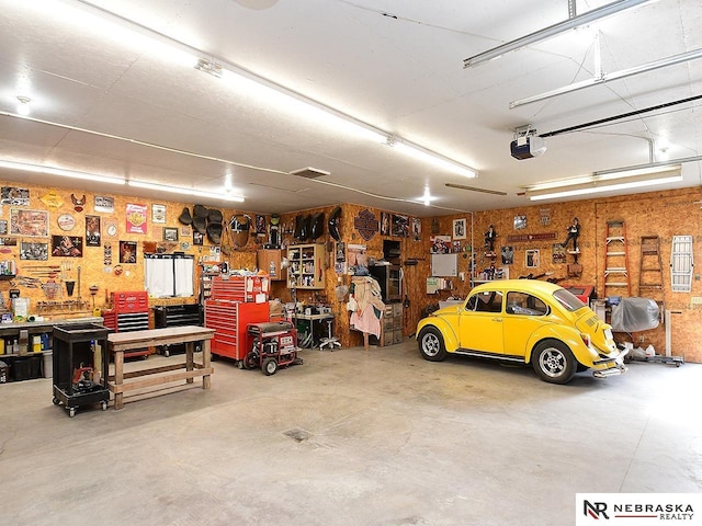 garage featuring a workshop area and a garage door opener