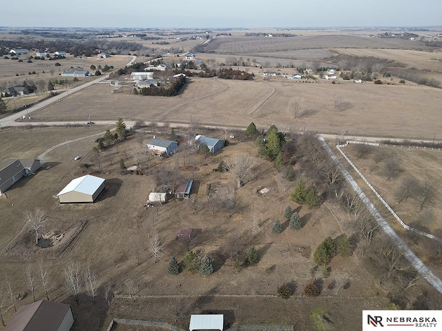 birds eye view of property with a rural view