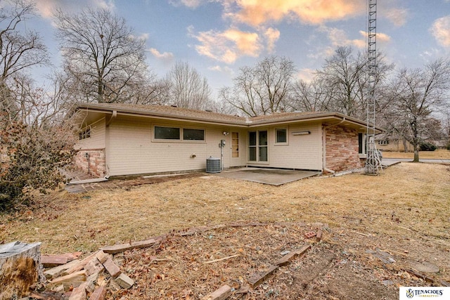 back of property featuring stone siding, a patio area, and brick siding