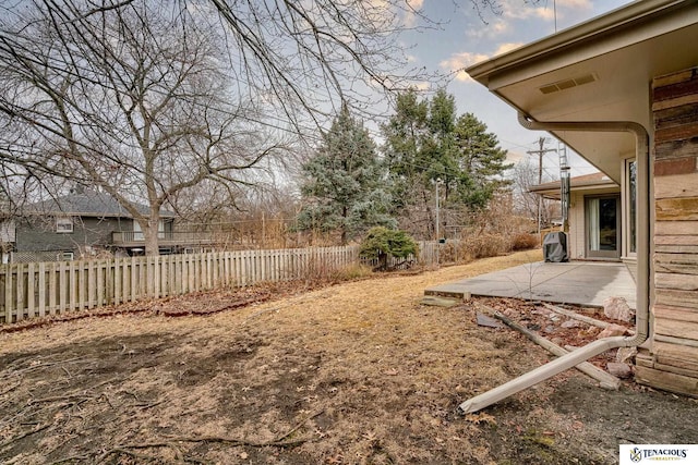 view of yard with a patio area and a fenced backyard