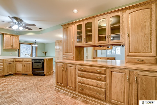 kitchen with a peninsula, black dishwasher, glass insert cabinets, and light countertops