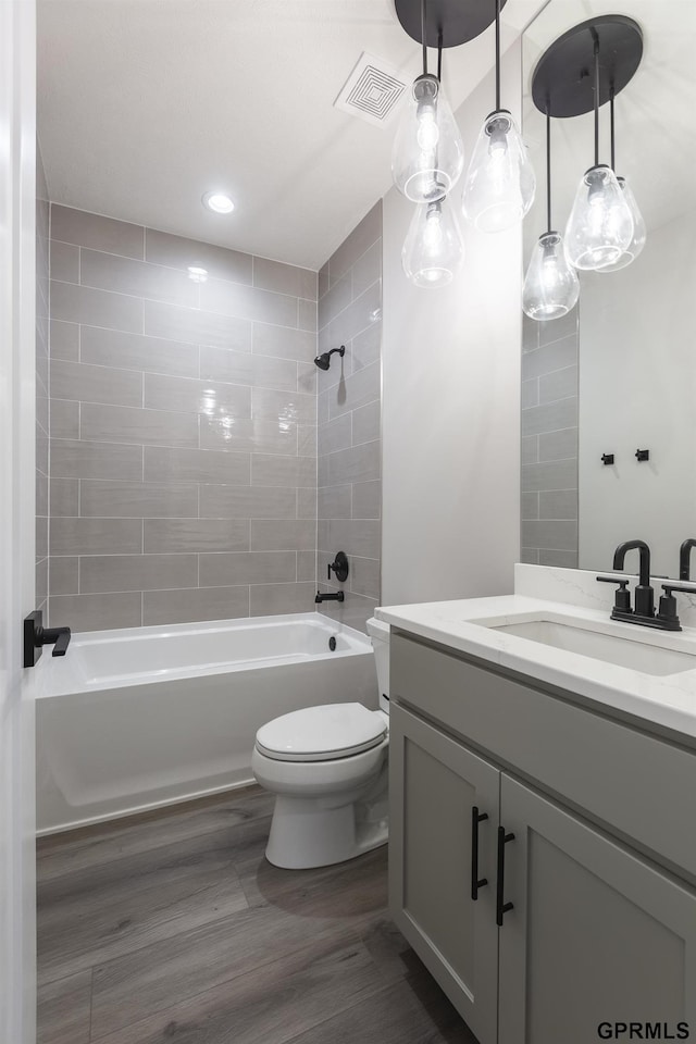 full bathroom with toilet, recessed lighting, bathing tub / shower combination, vanity, and visible vents