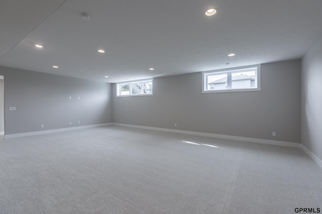 interior space with recessed lighting, light colored carpet, and baseboards