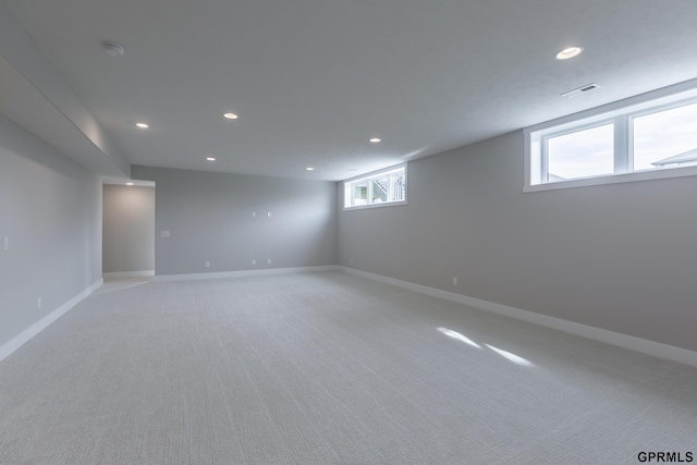 basement with baseboards, visible vents, and recessed lighting