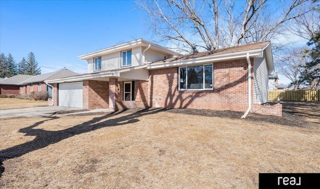 tri-level home with a garage, driveway, fence, and brick siding