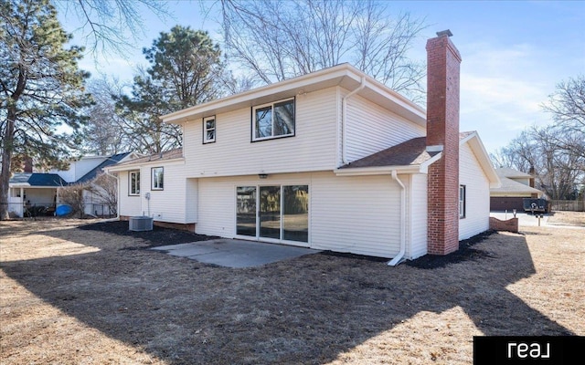 back of property featuring a patio, a chimney, and fence