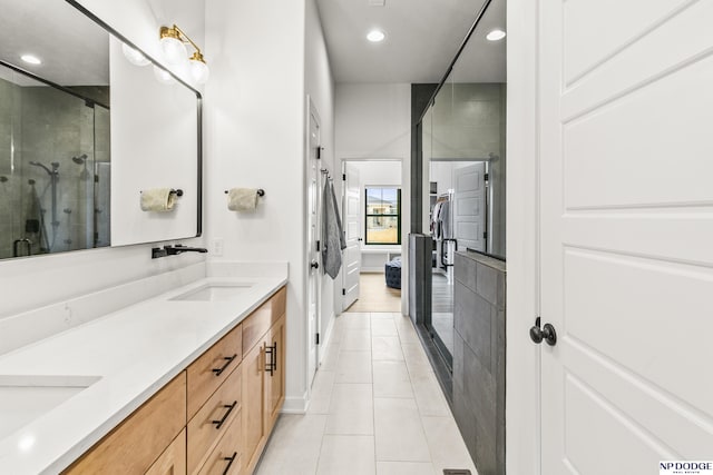 full bathroom featuring double vanity, recessed lighting, a sink, a shower stall, and tile patterned flooring