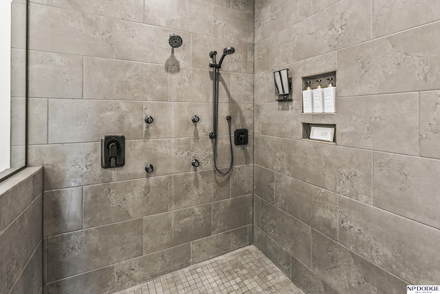 bathroom with a tile shower