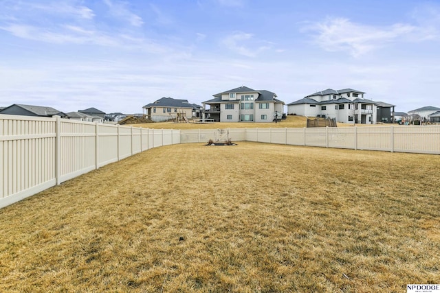 view of yard featuring a residential view and a fenced backyard