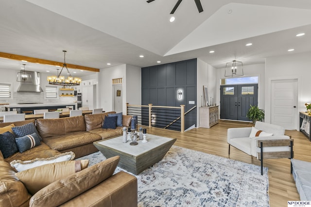 living room featuring high vaulted ceiling, light wood-type flooring, and recessed lighting