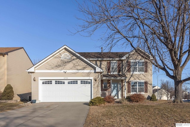 traditional-style home featuring an attached garage and concrete driveway