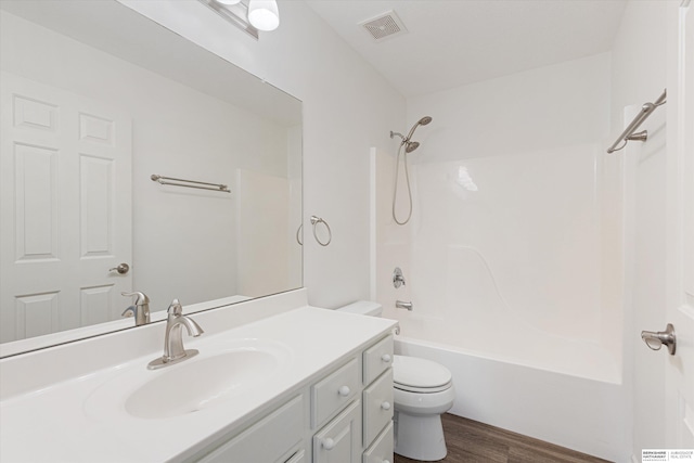 full bathroom with bathtub / shower combination, visible vents, toilet, vanity, and wood finished floors