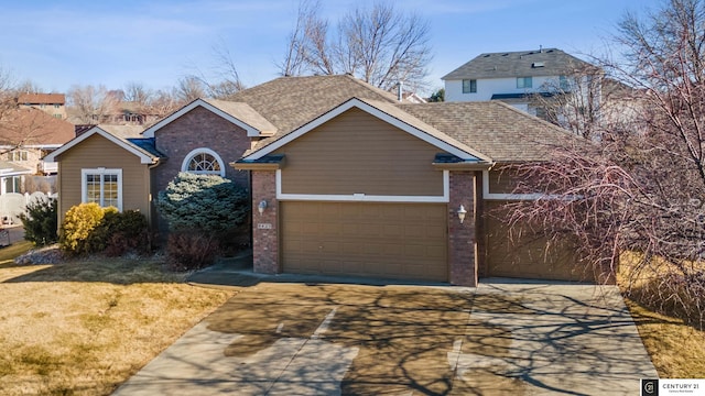 view of front of property with a garage, a shingled roof, concrete driveway, a front lawn, and brick siding