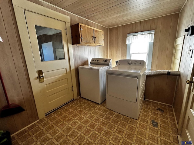 laundry room with dark floors, cabinet space, and wood walls