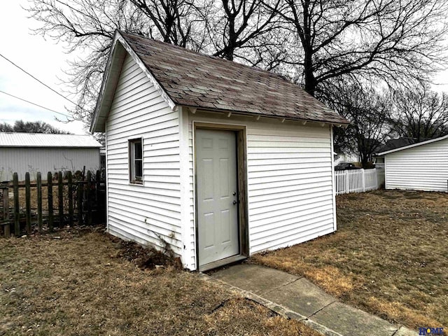 view of shed featuring fence