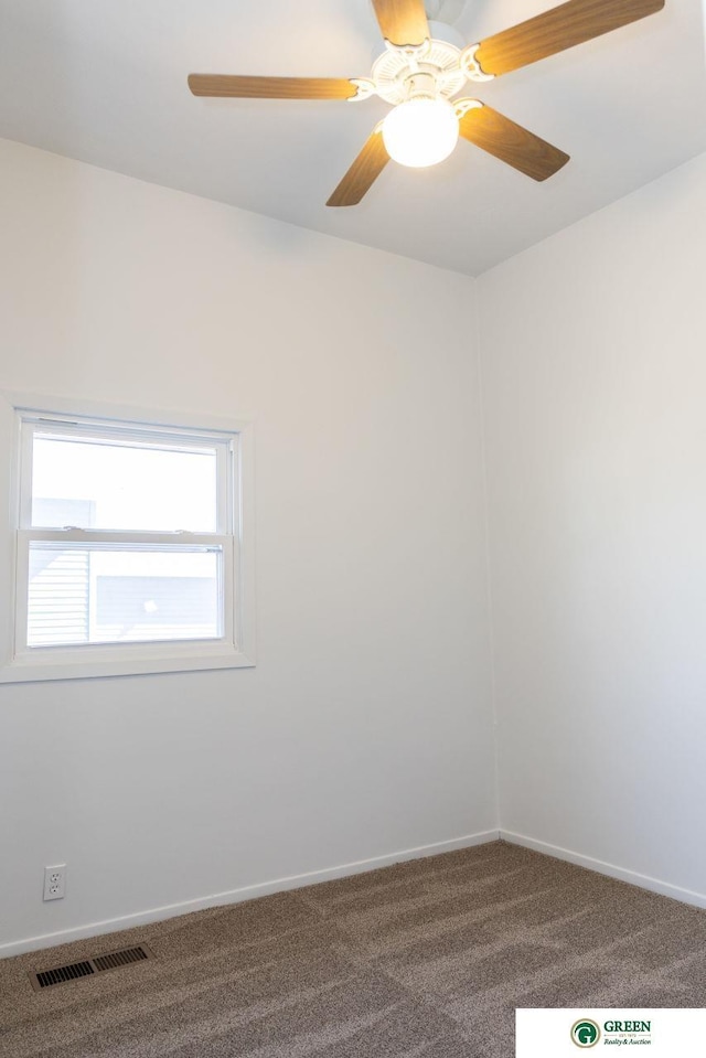 empty room featuring ceiling fan, carpet floors, visible vents, and baseboards