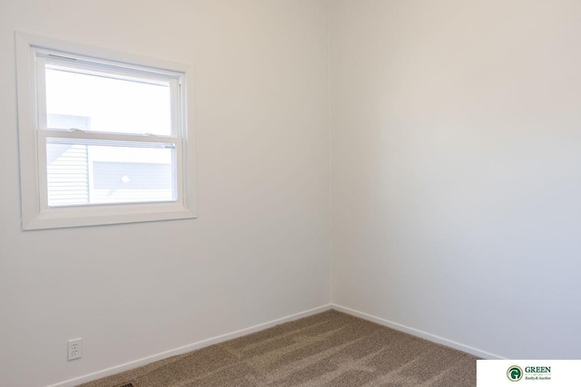 unfurnished room with carpet and baseboards