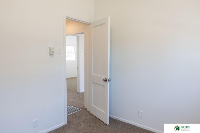 unfurnished room featuring carpet flooring and baseboards