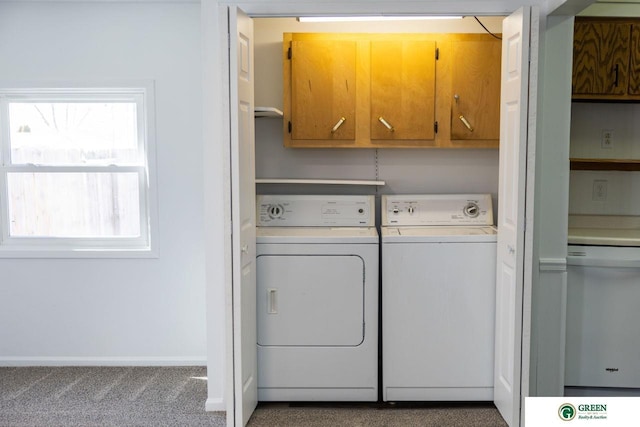 washroom with carpet floors, washing machine and clothes dryer, cabinet space, and baseboards