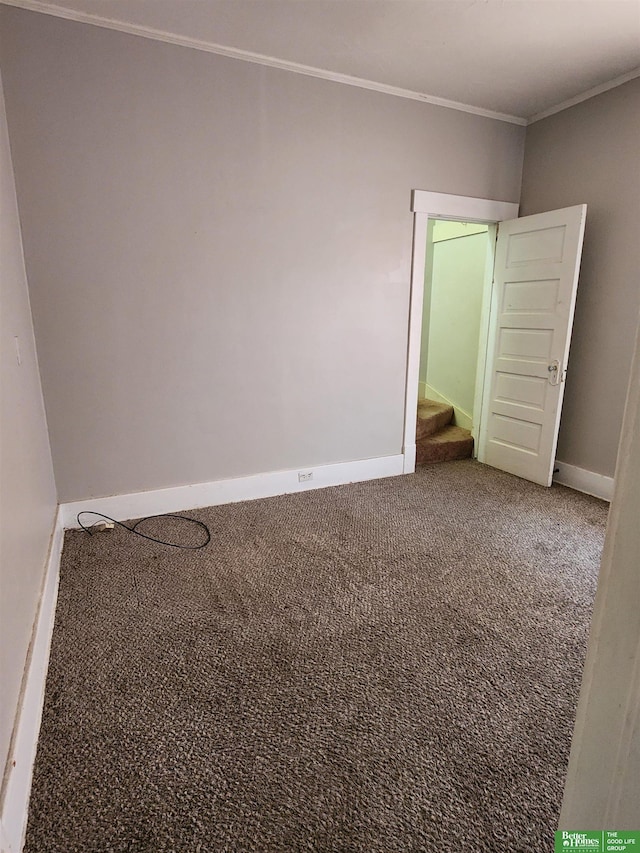 empty room featuring baseboards, stairs, ornamental molding, and carpet flooring