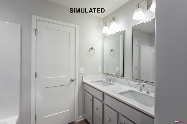 bathroom featuring double vanity and a sink