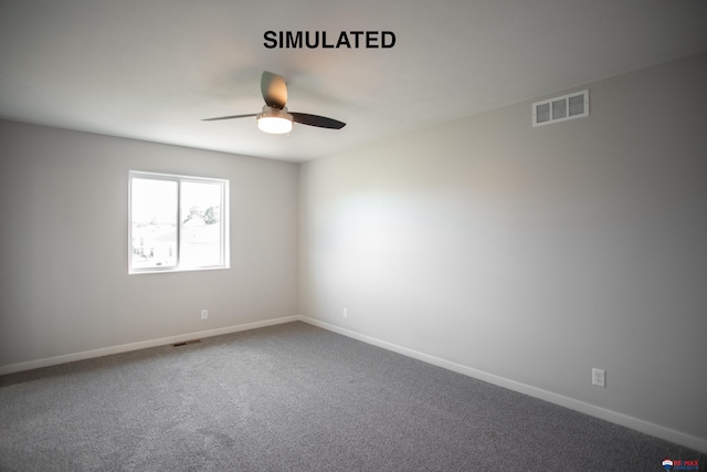 carpeted spare room with visible vents, ceiling fan, and baseboards