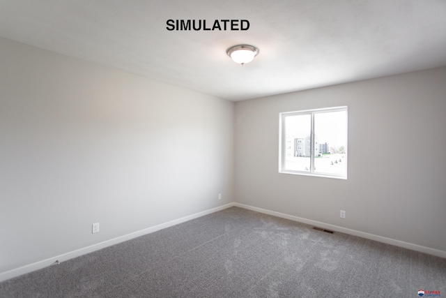 carpeted empty room with baseboards and visible vents